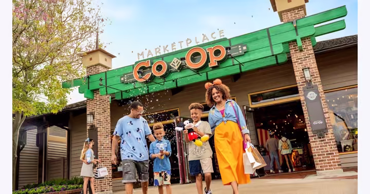 Guests carrying shopping bags outside Marketplace Co-Op at Disney Springs