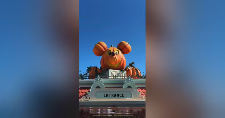 Pumpkin-shaped Mickey decoration above a Disneyland entrance