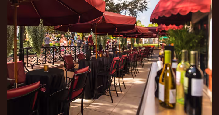 Official photograph of the Brown Derby Lounge patio before refurbishment, with red umbrellas over the tables