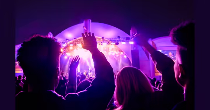 Guests raise their hands during a Rock the Universe concert at Universal Studios Florida