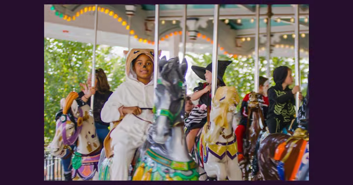 A child riding the carousel during Hersheypark Halloween