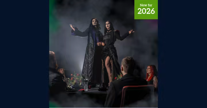 Dine with the Dead performers stand on a banquet table at Alton Towers