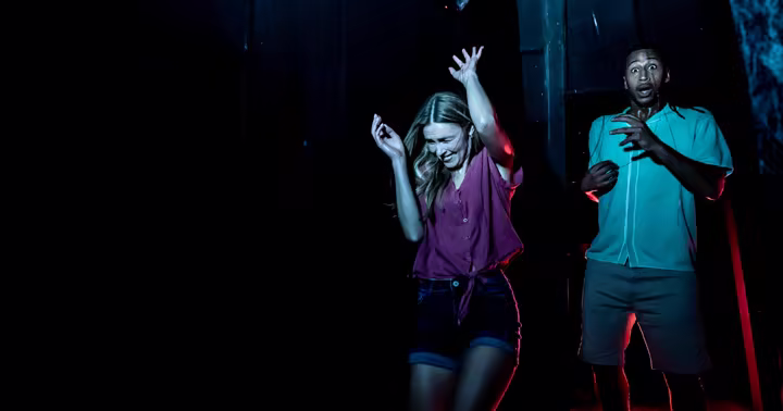 Two guests react inside a SeaWorld Orlando Howl-O-Scream haunted house