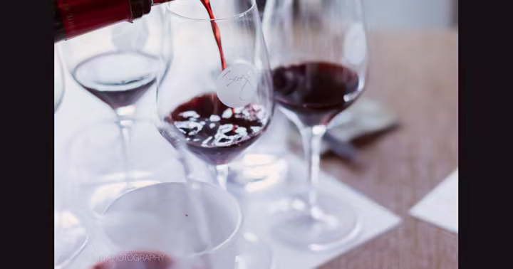 Red wine poured into tasting glasses at Wine Bar George