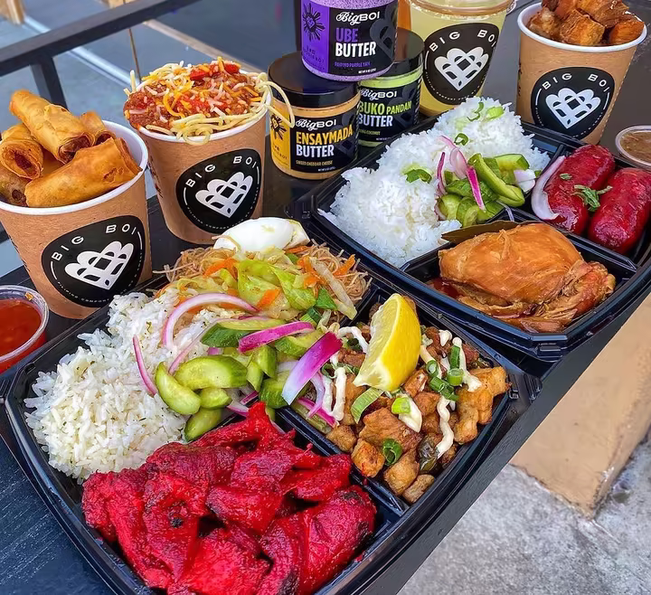Big Boi Filipino food spread with branded lumpia cups, rice plates, sauces, and ube butter jars