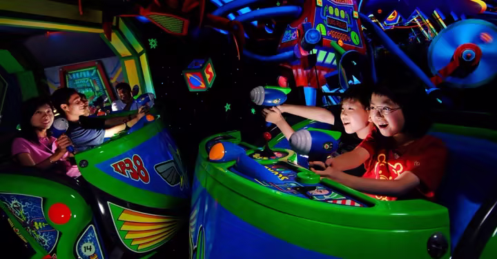 Families ride Buzz Lightyear Astro Blasters at Disneyland Park