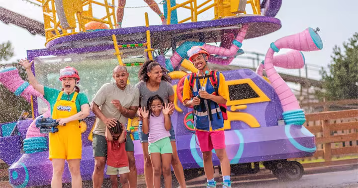 Performers spray water beside guests during SPLASH! Water Parade at Carowinds