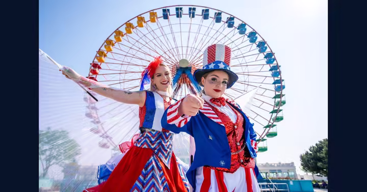 Patriotic performers pose in front of the Cedar Point Giant Wheel