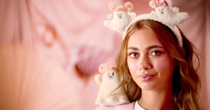 Model wearing a pastel Disney Cutie Ghost ear headband