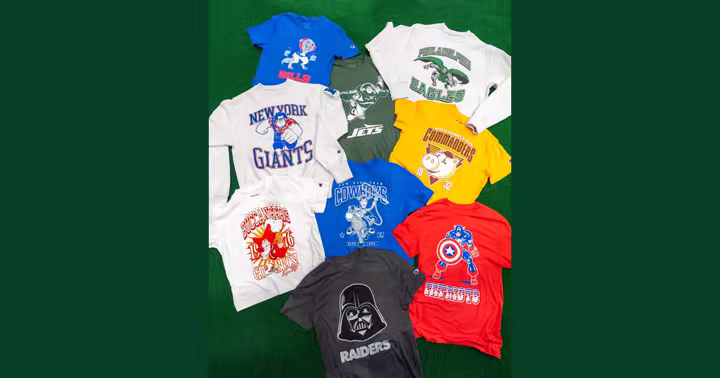 Disney and Champion NFL shirts for several teams arranged on green turf