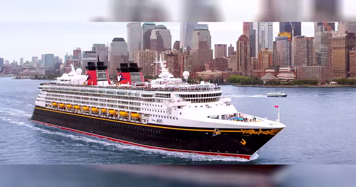 Disney Cruise Line ship sailing past the Lower Manhattan skyline