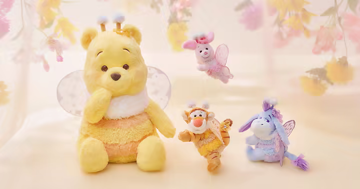 Fairy Pooh plush characters with wings and antennae in a Disney Store Japan collection banner