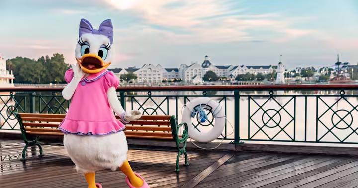 Daisy Duck stands beside the waterfront at Disney’s Yacht and Beach Club Resorts