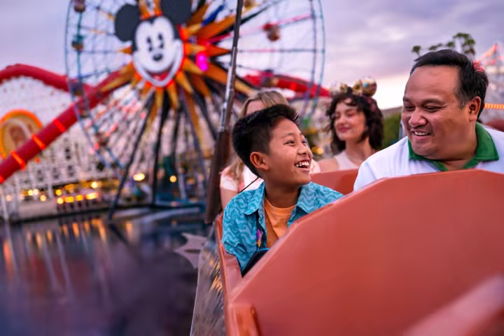 Guests at Disney California Adventure with Pixar Pal-A-Round in the background.