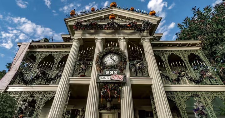 Haunted Mansion Holiday decorations on the Haunted Mansion facade at Disneyland Park