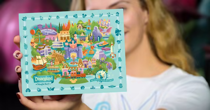 Guest holding a Disneyland Resort Magic Key park map activity card