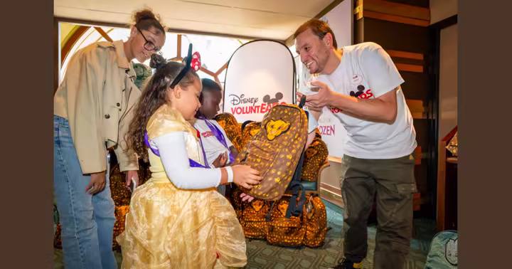 Children receive school supplies from Disney VoluntEARS at Disneyland Paris