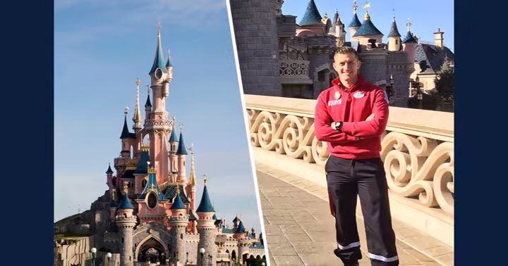 A Disneyland Paris Fire and Rescue team member beside Sleeping Beauty Castle