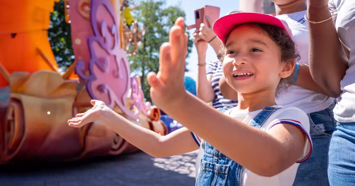 A child waves from a Disneyland Paris parade float
