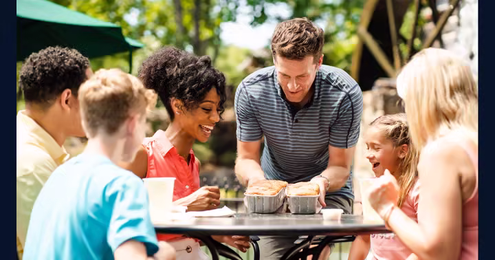 Family eating together outdoors at Dollywood in an official park image