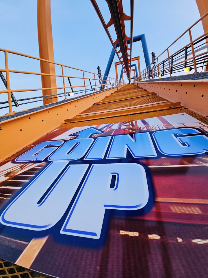 Going Up sign beneath Talon's orange track at Dorney Park