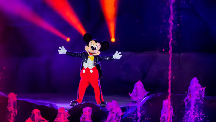 Mickey Mouse in Fantasmic at Disney's Hollywood Studios with red show lights behind him
