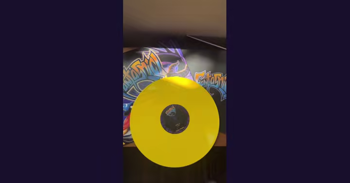 Fantasmic! album sleeve beside an opaque yellow vinyl record