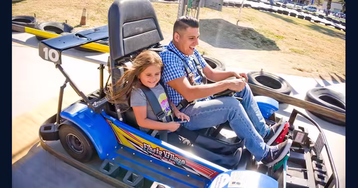 Guests riding a Fiesta Village go-kart on the park's official attraction page