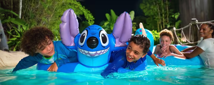 Guests floating with a Stitch inner tube at Disney's Typhoon Lagoon