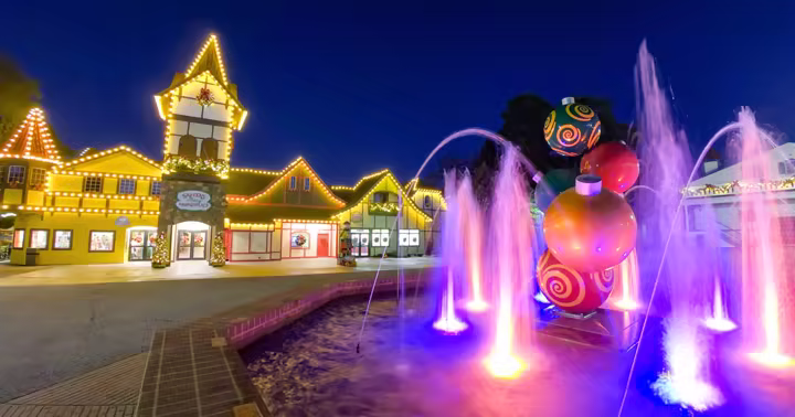 Holiday World buildings, fountains and Christmas decorations lit at night