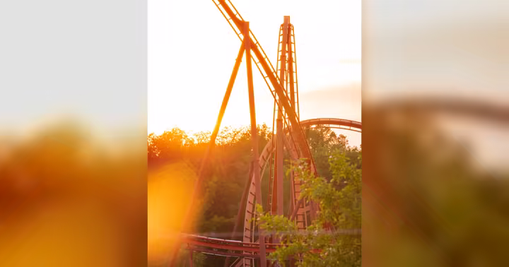 Orange roller coaster track at Holiday World during sunset