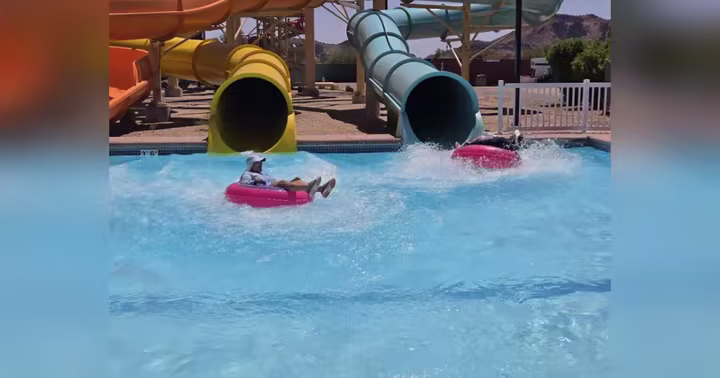 Guests riding tubes through Hurricane Harbor Phoenix water slides