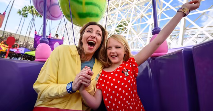A mother and daughter ride Inside Out Emotional Whirlwind at Disney California Adventure