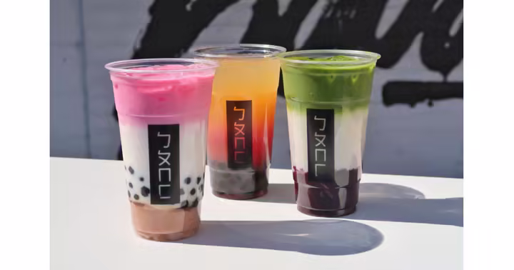 Three Bopo Go boba drinks on a white tabletop
