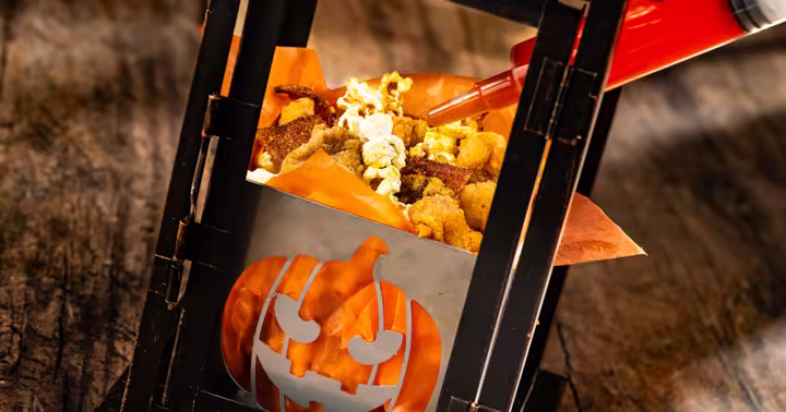 Midnight Mayhem Popcorn Chicken served in a pumpkin-sided lantern at Jock Lindsey’s Hangar Bar