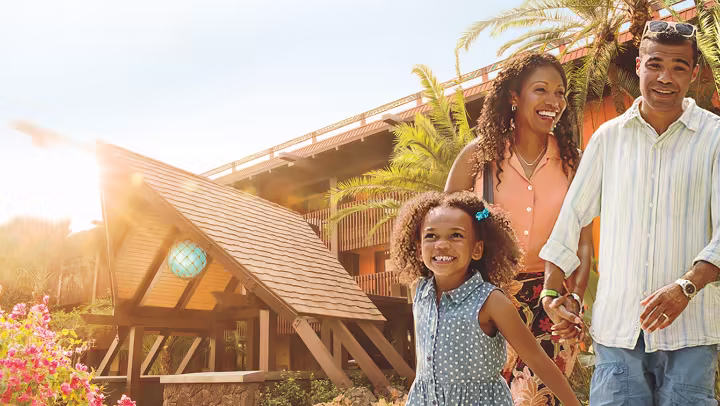 A family outside a Disney Vacation Club resort building at Walt Disney World