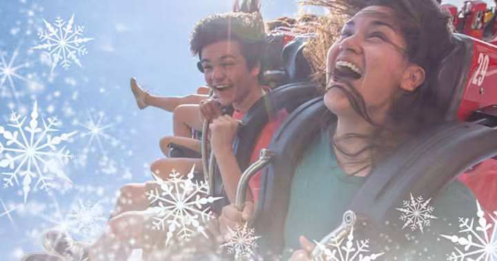 Kings Dominion riders surrounded by Christmas in July snowflakes