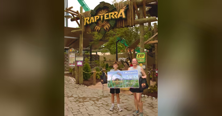 Rapterra guests pose with a one-millionth-rider sign at Kings Dominion