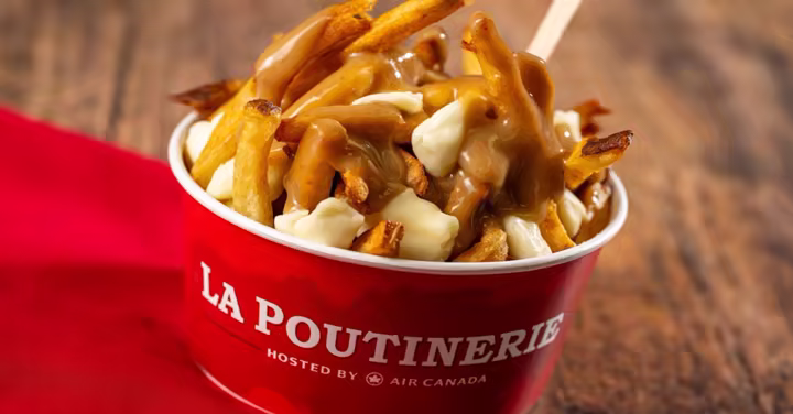 Classic poutine in a cup with cheese curds and gravy at La Poutinerie in EPCOT