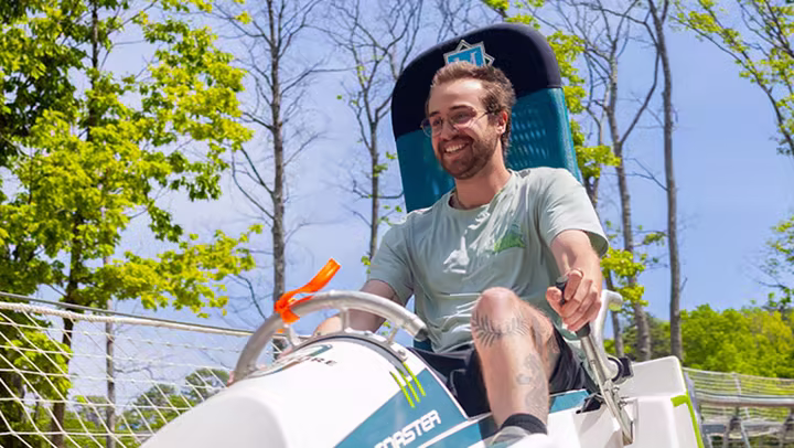 A rider on the Mountain Mayhem alpine coaster at Massanutten Resort