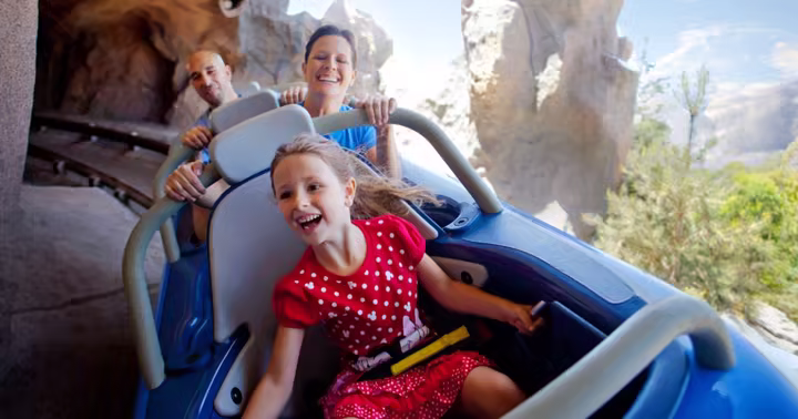 A family rides Matterhorn Bobsleds at Disneyland Park