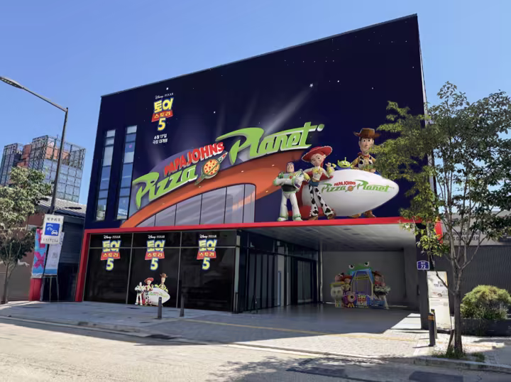 Papa Johns Pizza Planet storefront decorated for Toy Story 5