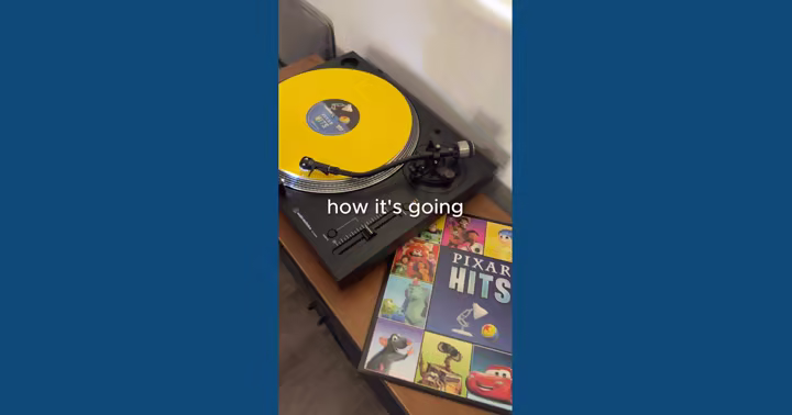 Yellow Pixar Hits vinyl record beside its blue album sleeve