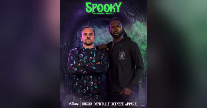 Two models wear Disney spooky performance hoodies under a Spooky Performance Hoodies sign