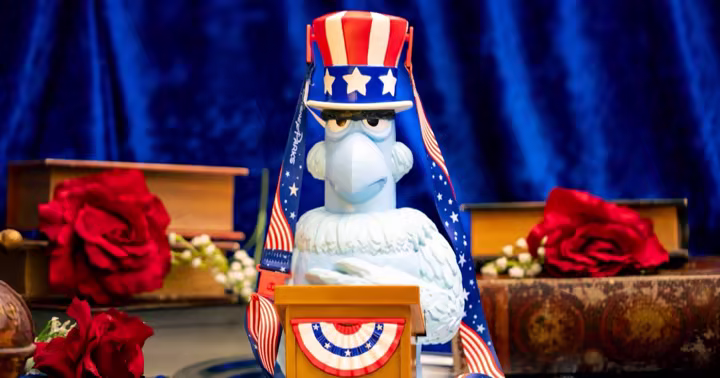 Sam Eagle Bucket with a patriotic top hat, bunting-trimmed podium, and red, white, and blue strap