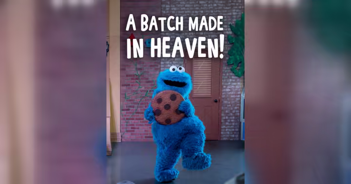 Cookie Monster holds a giant chocolate chip cookie at Sesame Place Philadelphia