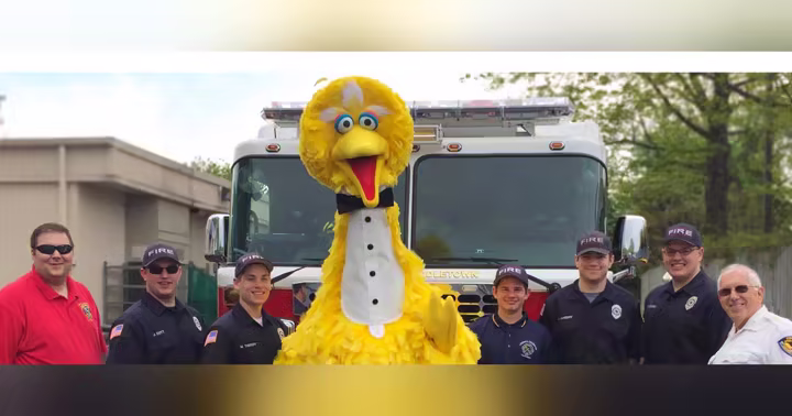 Big Bird stands with firefighters and other first responders at Sesame Place Philadelphia