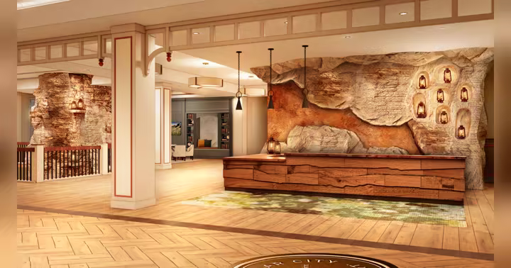 Official Silver Dollar City Resort reception rendering with a cave-inspired stone wall and wood desk