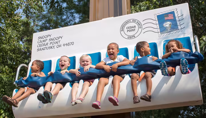 Family with young children on a Six Flags walkway
