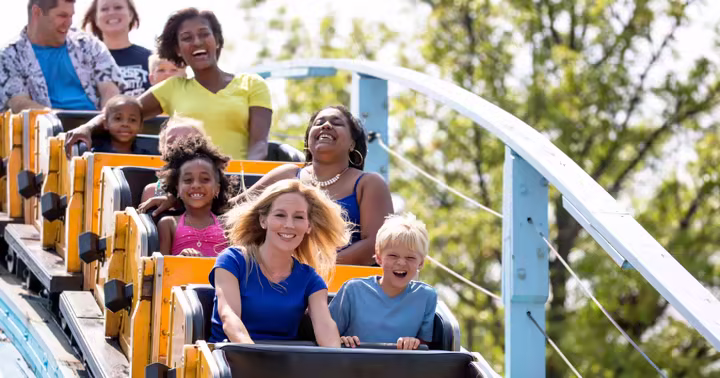 Families riding a Six Flags roller coaster in an official Pre-K Pass photo